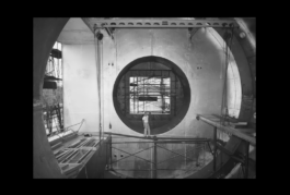 An engineer stands within the structure of a supersonic jet. 